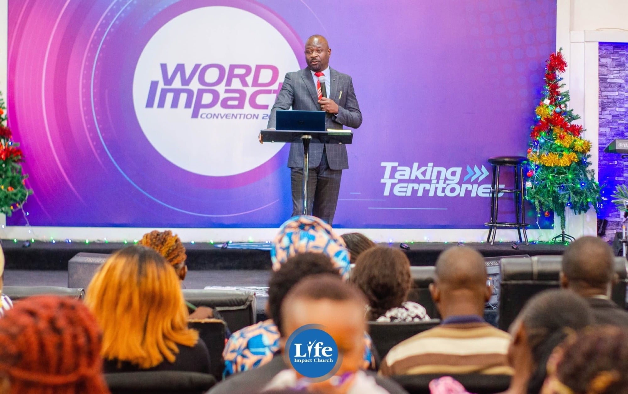 Preaching to a full hall at the Word Impact Convention