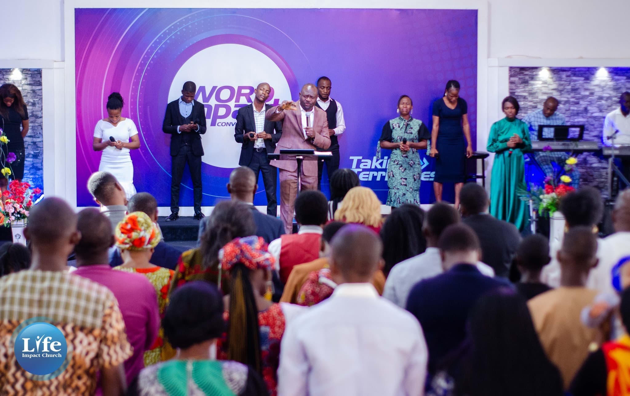 The congregation gathered before the stage